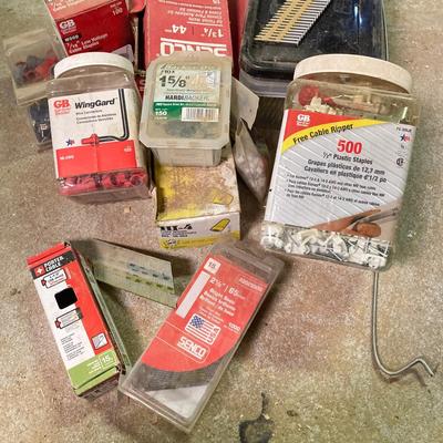 LOT 254: Pipe Clamps, Box of Grip Rite Framing Nails, Plastic Staples, Wing Guards, Hardware and More