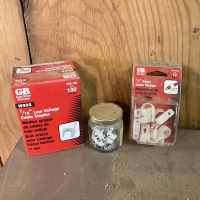 LOT 254: Pipe Clamps, Box of Grip Rite Framing Nails, Plastic Staples, Wing Guards, Hardware and More