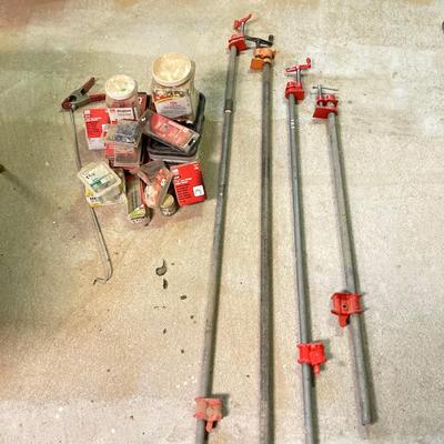 LOT 254: Pipe Clamps, Box of Grip Rite Framing Nails, Plastic Staples, Wing Guards, Hardware and More