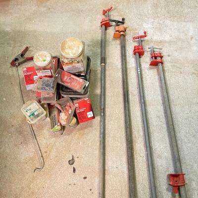 LOT 254: Pipe Clamps, Box of Grip Rite Framing Nails, Plastic Staples, Wing Guards, Hardware and More