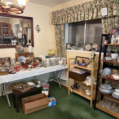 Sale Photo Thumbnail #32: Dishes, tins, glassware, books, custom curtains, mirror, silverware, framed art, etc
****Table, table cloth, plastic shelf, 2 wooden shelves, plate stands not included)****