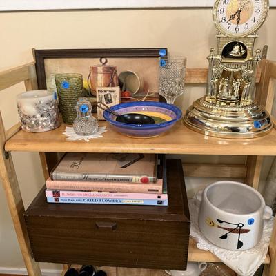 Sale Photo Thumbnail #36: Dishes, tins, glassware, books, custom curtains, mirror, silverware, framed art, etc
****Table, table cloth, plastic shelf, 2 wooden shelves, plate stands not included)****