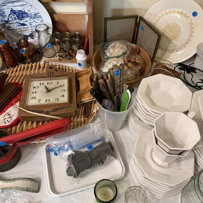 Sale Photo Thumbnail #42: Dishes, tins, glassware, books, custom curtains, mirror, silverware, framed art, etc
****Table, table cloth, plastic shelf, 2 wooden shelves, plate stands not included)****