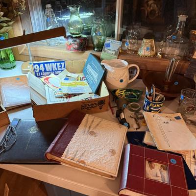 Sale Photo Thumbnail #54: Upholstered chair, lamps, candles, wood file cabinet, metal cabinet, ephemera, dishes, vases, decor, wall paper, ribbon, baskets, mirror,  railroad memorabilia, local advertising items, metal art, records, 8Track, cassettes, etc
****Table, wire shelf, pla