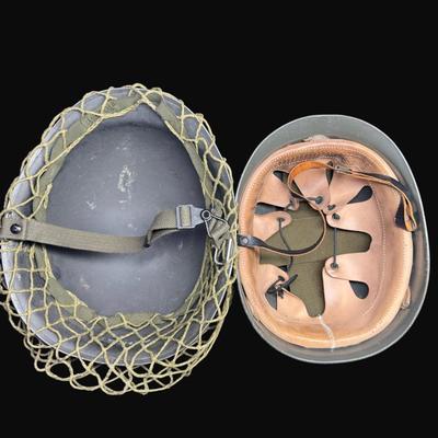 Sale Photo Thumbnail #323: Includes two Korean/Vietnam Era helmets with liners, a USMC flight cap, a USN "Dixie Cup" hat, and a WWII Era Haversack. Total of five pieces. Age related wear. [JP]