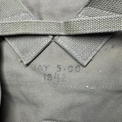 Sale Photo Thumbnail #318: Includes two Korean/Vietnam Era helmets with liners, a USMC flight cap, a USN "Dixie Cup" hat, and a WWII Era Haversack. Total of five pieces. Age related wear. [JP]