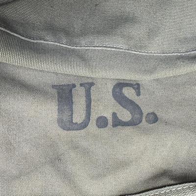 Sale Photo Thumbnail #319: Includes two Korean/Vietnam Era helmets with liners, a USMC flight cap, a USN "Dixie Cup" hat, and a WWII Era Haversack. Total of five pieces. Age related wear. [JP]