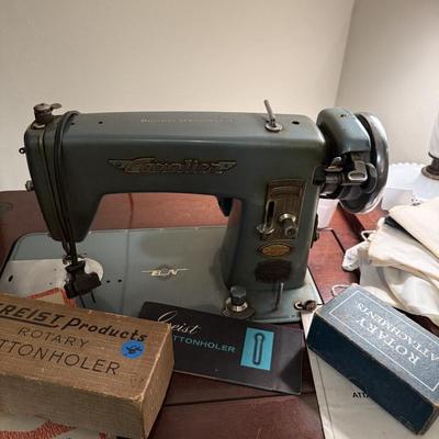 Sale Photo Thumbnail #133: Cavalier sewing machine in cabinet w/chair, lamp, sewing supplies, notions, material, lace, framed artwork 
DOES NOT INCLUDE: table, stacking baskets