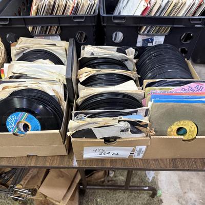 Sale Photo Thumbnail #153: 1st garage middle section
Records, China, coffee table, tow bar, cigar boxes, miscellaneous, toaster oven, card table
DOES NOT INCLUDE: Wooden tables,