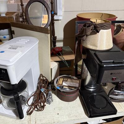 Sale Photo Thumbnail #318: Middle garage: saw horses, long boards, misc kitchen items, fan, cabinet, chair, painting tools, coffee maker, toaster, toaster ovens, hanging lamp, scrap wood, & more