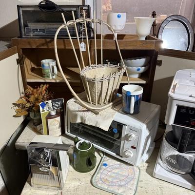 Sale Photo Thumbnail #319: Middle garage: saw horses, long boards, misc kitchen items, fan, cabinet, chair, painting tools, coffee maker, toaster, toaster ovens, hanging lamp, scrap wood, & more