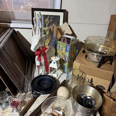 Sale Photo Thumbnail #313: Middle garage: saw horses, long boards, misc kitchen items, fan, cabinet, chair, painting tools, coffee maker, toaster, toaster ovens, hanging lamp, scrap wood, & more