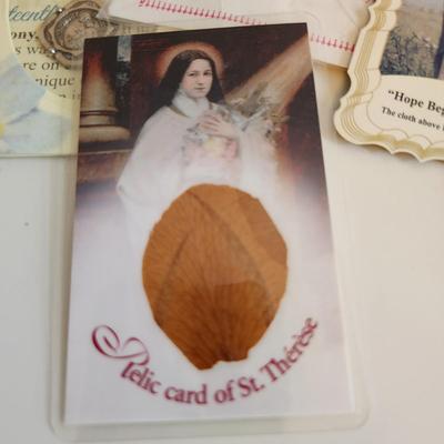 Sale Photo Thumbnail #218: This auction lot is for a gathering of Religious Relics, Beads, Medal & Prayer Cards.  This grouping includes "touched-to" relics of St. Jude, St. Theresa, St. Francis of Assissi and St. Faustina.  Also included is a St. Theresa Chaplet of Beads and a med