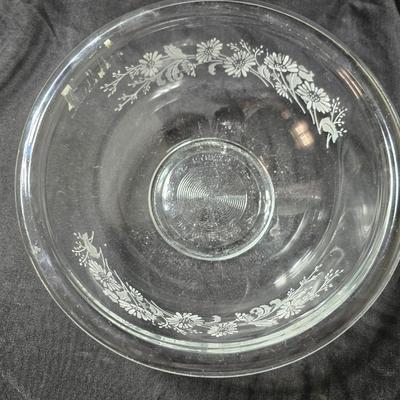 Three vintage Pyrex clear glass nesting mixing bowls in the "Colonial Mist" or "White Lace" pattern.