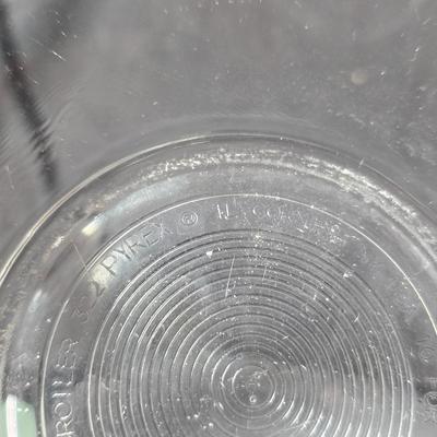 Three vintage Pyrex clear glass nesting mixing bowls in the "Colonial Mist" or "White Lace" pattern.