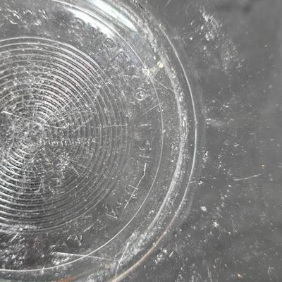 Three vintage Pyrex clear glass nesting mixing bowls in the "Colonial Mist" or "White Lace" pattern.