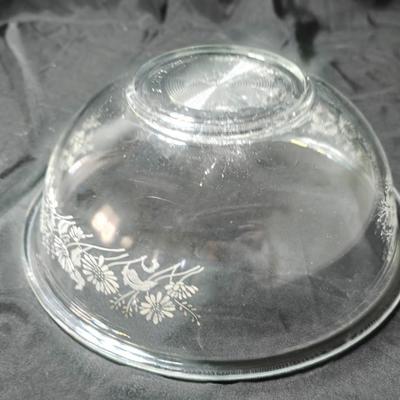 Three vintage Pyrex clear glass nesting mixing bowls in the "Colonial Mist" or "White Lace" pattern.