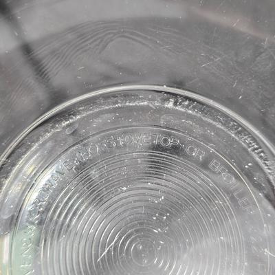 Three vintage Pyrex clear glass nesting mixing bowls in the "Colonial Mist" or "White Lace" pattern.