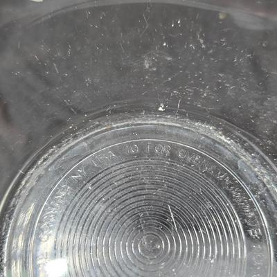 Three vintage Pyrex clear glass nesting mixing bowls in the "Colonial Mist" or "White Lace" pattern.