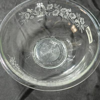Three vintage Pyrex clear glass nesting mixing bowls in the "Colonial Mist" or "White Lace" pattern.