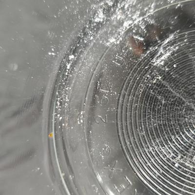 Three vintage Pyrex clear glass nesting mixing bowls in the "Colonial Mist" or "White Lace" pattern.