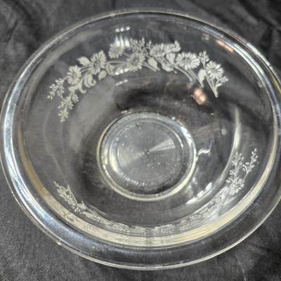 Three vintage Pyrex clear glass nesting mixing bowls in the "Colonial Mist" or "White Lace" pattern.