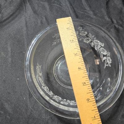 Three vintage Pyrex clear glass nesting mixing bowls in the "Colonial Mist" or "White Lace" pattern.