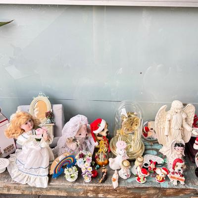 Sale Photo Thumbnail #147: Dolls, praying, wedding Teddy bear, Large porcelain angel, dog figurines, Betty Boop, Mickey Mouse. New Lenox set in box, 3 Royal Dalton porcelain flower pieces in good condition. Perpetual clock, with glass dome, untested needs new battery, but all there