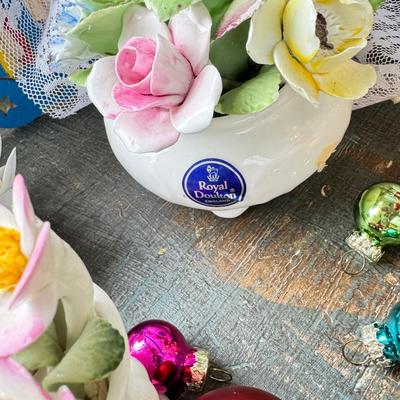 Sale Photo Thumbnail #152: Dolls, praying, wedding Teddy bear, Large porcelain angel, dog figurines, Betty Boop, Mickey Mouse. New Lenox set in box, 3 Royal Dalton porcelain flower pieces in good condition. Perpetual clock, with glass dome, untested needs new battery, but all there