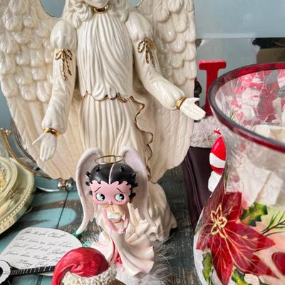 Sale Photo Thumbnail #158: Dolls, praying, wedding Teddy bear, Large porcelain angel, dog figurines, Betty Boop, Mickey Mouse. New Lenox set in box, 3 Royal Dalton porcelain flower pieces in good condition. Perpetual clock, with glass dome, untested needs new battery, but all there