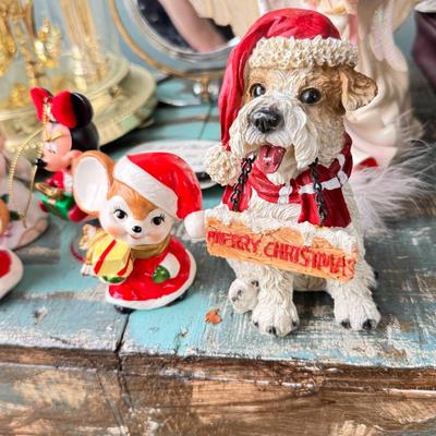 Sale Photo Thumbnail #157: Dolls, praying, wedding Teddy bear, Large porcelain angel, dog figurines, Betty Boop, Mickey Mouse. New Lenox set in box, 3 Royal Dalton porcelain flower pieces in good condition. Perpetual clock, with glass dome, untested needs new battery, but all there