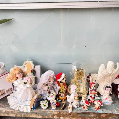 Sale Photo Thumbnail #165: Dolls, praying, wedding Teddy bear, Large porcelain angel, dog figurines, Betty Boop, Mickey Mouse. New Lenox set in box, 3 Royal Dalton porcelain flower pieces in good condition. Perpetual clock, with glass dome, untested needs new battery, but all there