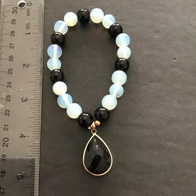 Sale Photo Thumbnail #47: Beautiful glass beaded stretch bracelet with pendant . Please see attached photos.