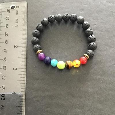 Sale Photo Thumbnail #49: Multicolored  glass beaded stretch bracelet with lava stones. Please see attached photos.