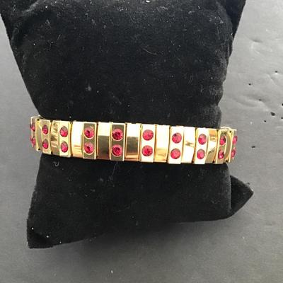 Sale Photo Thumbnail #116: Gold tone, stretch bracelet with red rhinestones. Please see attached photos.