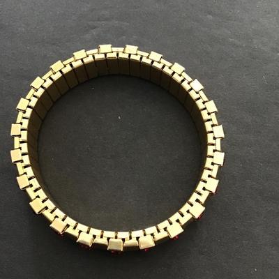 Sale Photo Thumbnail #117: Gold tone, stretch bracelet with red rhinestones. Please see attached photos.