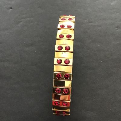 Sale Photo Thumbnail #118: Gold tone, stretch bracelet with red rhinestones. Please see attached photos.