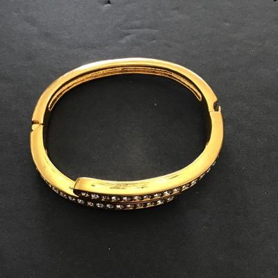 Sale Photo Thumbnail #155: Gold tone bracelet with rhinestone hinged. Please see attached photos.