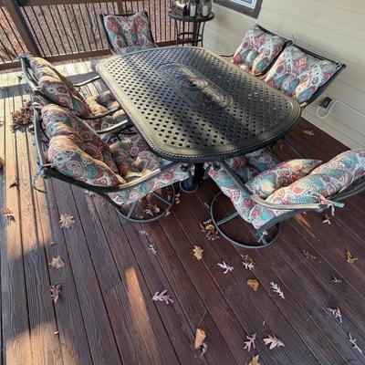 Sale Photo Thumbnail #1059: Black Cast Aluminum Outdoor Dining Table with Center Fire Pit, Six Swivel Chairs and cushions    Propane Fire Pit