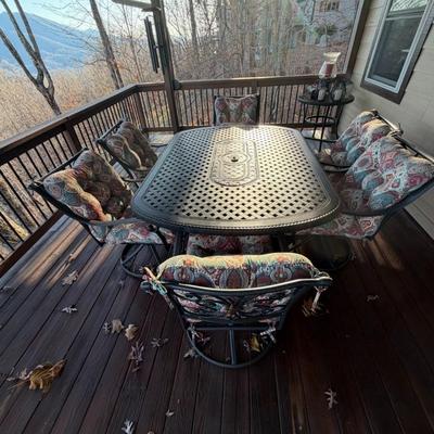 Sale Photo Thumbnail #1062: Black Cast Aluminum Outdoor Dining Table with Center Fire Pit, Six Swivel Chairs and cushions    Propane Fire Pit