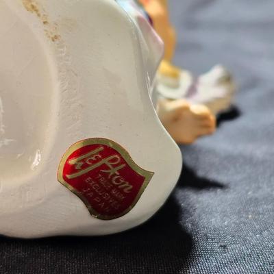 Vintage Lefton July Birthday Angel figurine, style #6224, featuring a ruby-red birthstone and blue flowers.