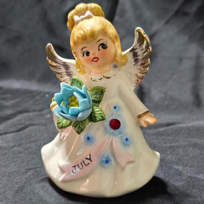 Vintage Lefton July Birthday Angel figurine, style #6224, featuring a ruby-red birthstone and blue flowers.