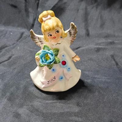 Vintage Lefton July Birthday Angel figurine, style #6224, featuring a ruby-red birthstone and blue flowers.