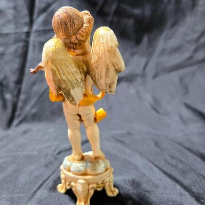 Vintage Fontanini Depose Italy cherub figurine, one standing and playing a violin, the other reclining with a floral garland.