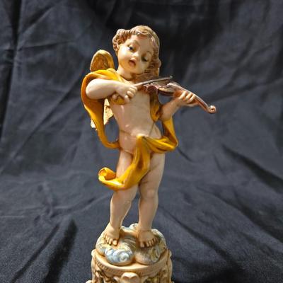 Vintage Fontanini Depose Italy cherub figurine, one standing and playing a violin, the other reclining with a floral garland.