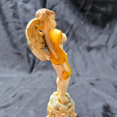 Vintage Fontanini Depose Italy cherub figurine, one standing and playing a violin, the other reclining with a floral garland.