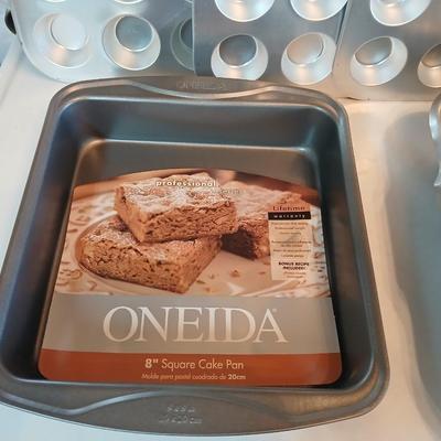 Bake ware = New Best Party pack 3 cake pan - 3 tiered cakes - Foly muffin tins - New Oneida 8" square cake pan and a large cake pan