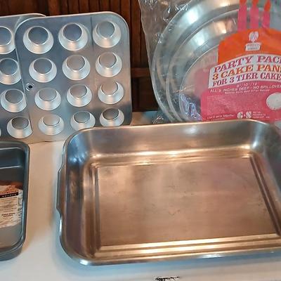 Bake ware = New Best Party pack 3 cake pan - 3 tiered cakes - Foly muffin tins - New Oneida 8" square cake pan and a large cake pan
