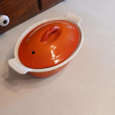 Vintage Le Creuset heritage-style Decoware mini dutch oven or casserole dish in the signature Flame Orange color.