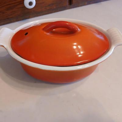 Vintage Le Creuset heritage-style Decoware mini dutch oven or casserole dish in the signature Flame Orange color.